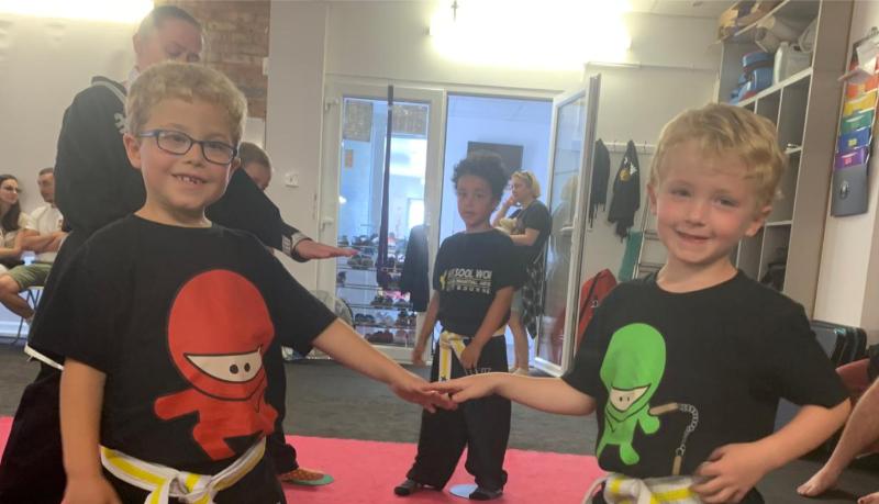 Young children holding hands in martial arts